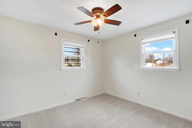 a view of a room with a ceiling fan