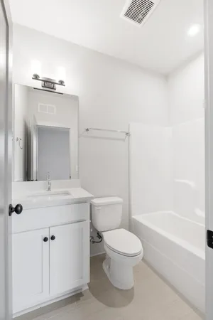 a bathroom with a toilet a sink and a bathtub