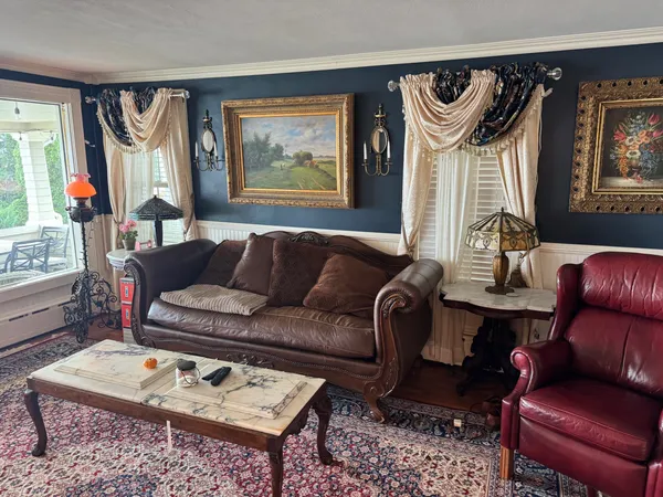 a living room with furniture a rug and a window