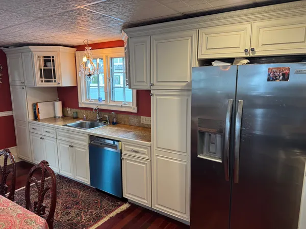 a kitchen with stainless steel appliances granite countertop a refrigerator and a stove