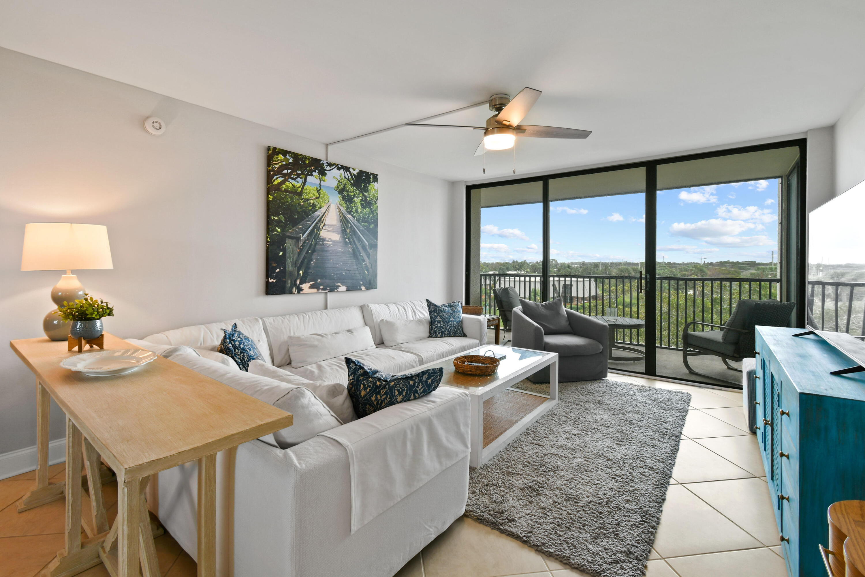 1605 Highway 1, Unit M1404 Jupiter, FL 33477 - Photo 11 of 42 a living room with furniture and a large window