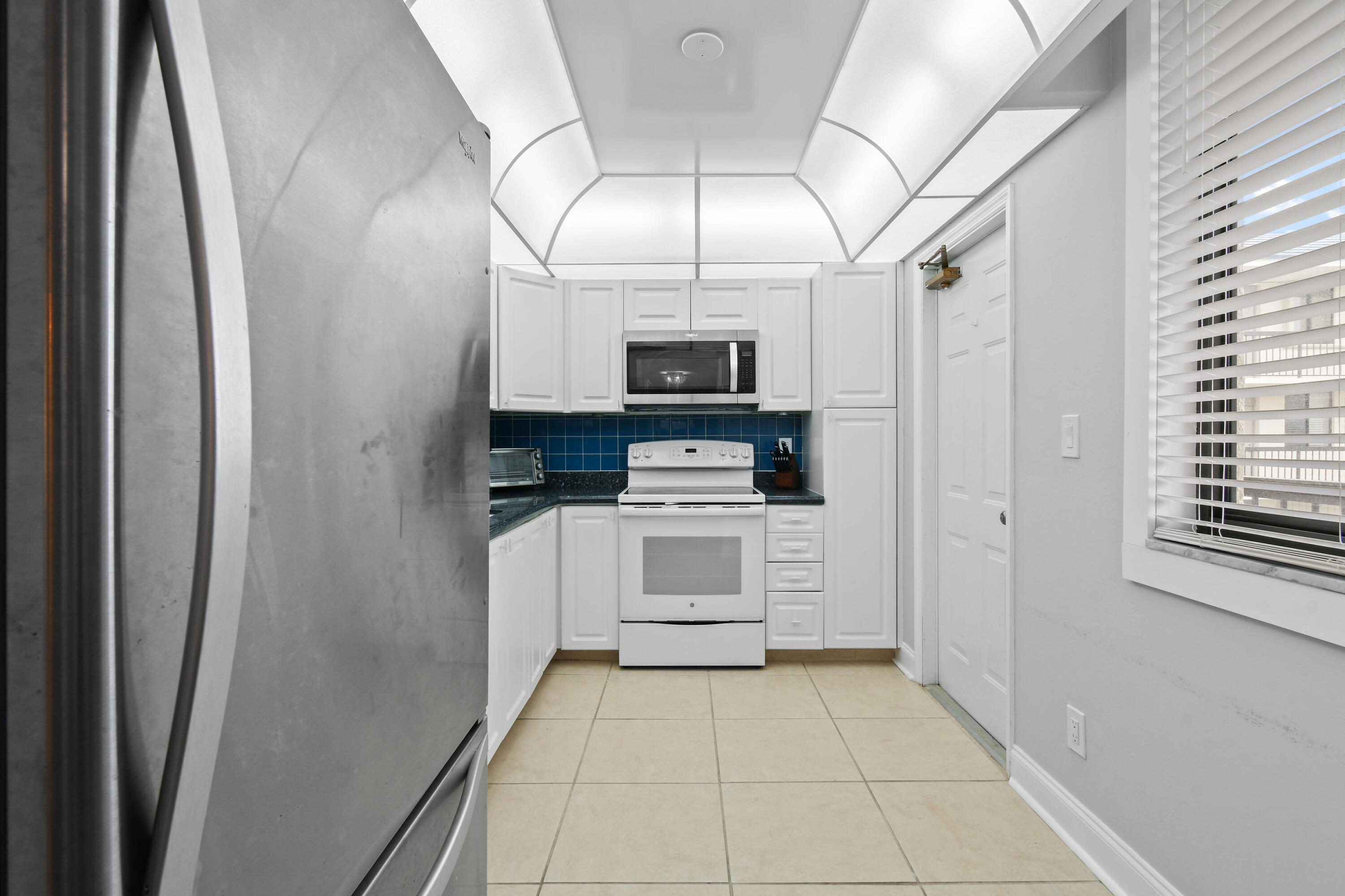 1605 Highway 1, Unit M1404 Jupiter, FL 33477 - Photo 15 of 42 a kitchen with stainless steel appliances a refrigerator and a stove top oven