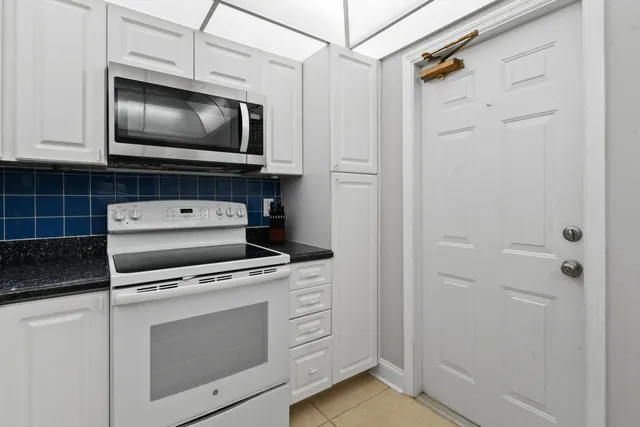 a kitchen with stainless steel appliances granite countertop a sink refrigerator and cabinets