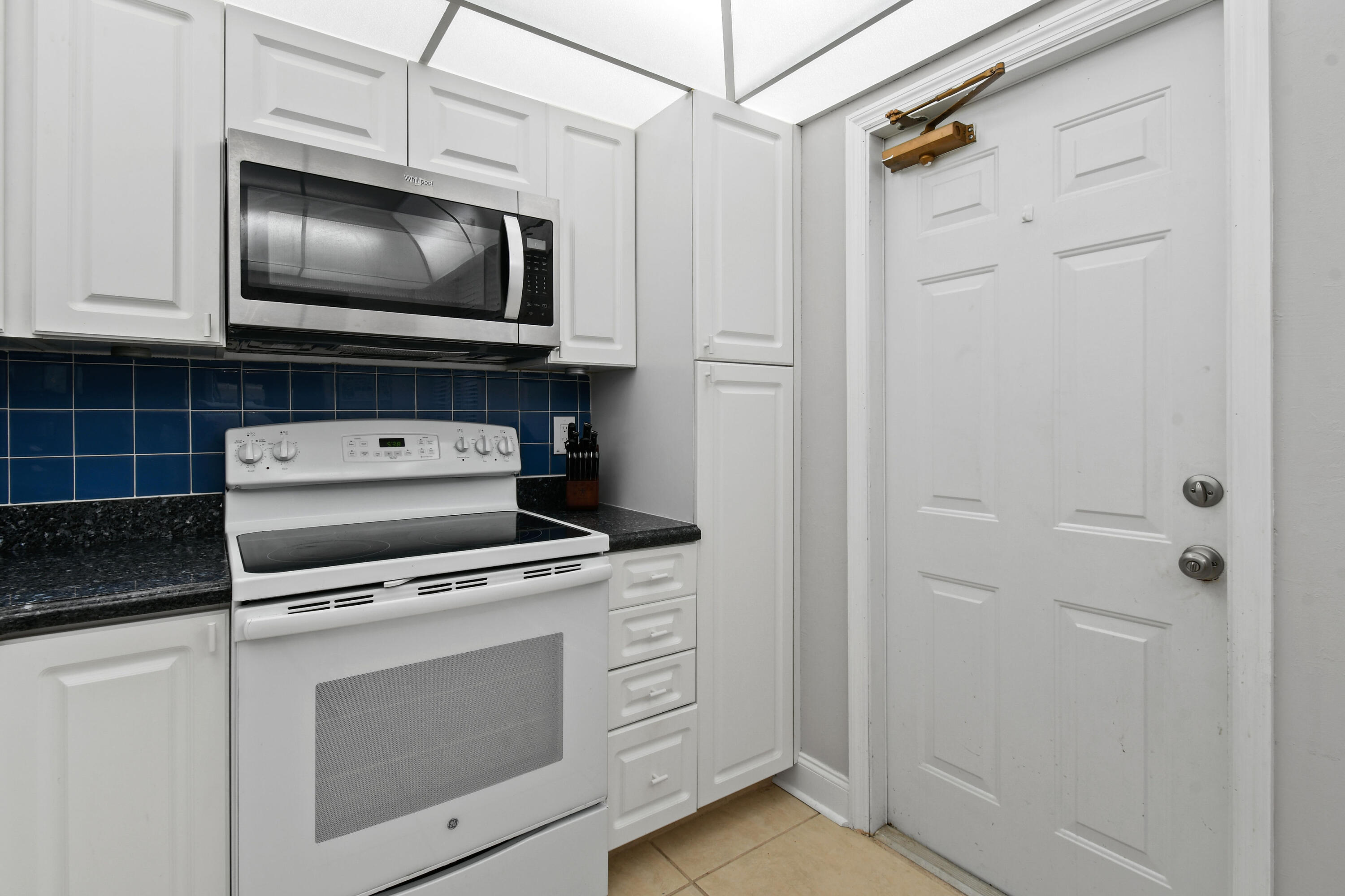 1605 Highway 1, Unit M1404 Jupiter, FL 33477 - Photo 17 of 42 a kitchen with white cabinets and stainless steel appliances
