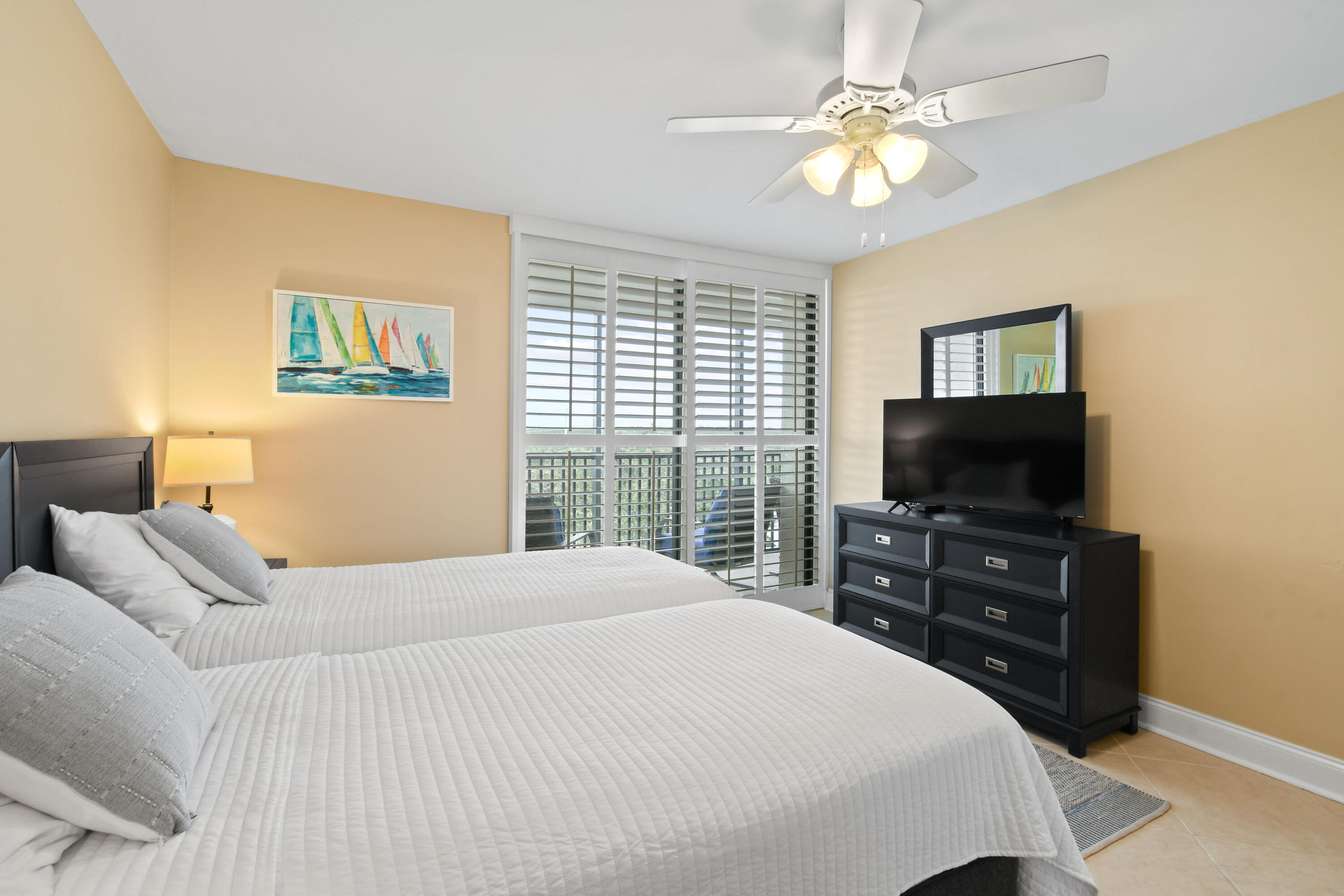 1605 Highway 1, Unit M1404 Jupiter, FL 33477 - Photo 29 of 42 a bedroom with a bed and a flat screen tv