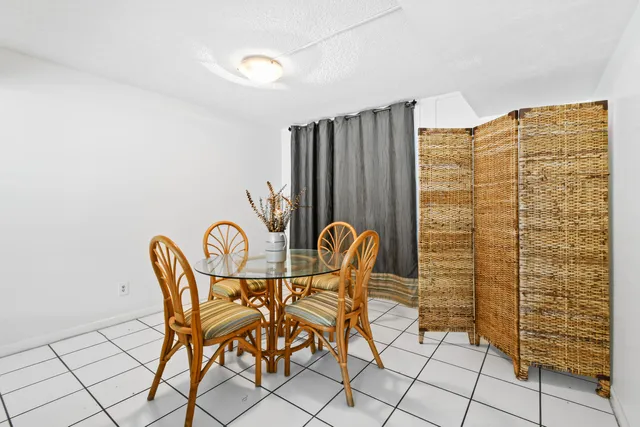 a view of a room with table and chairs