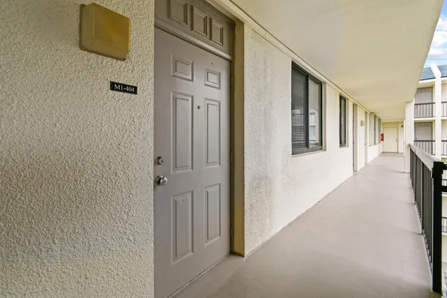 a view of a hallway with paintings on the wall