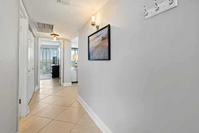 a dining room with furniture and a floor to ceiling window
