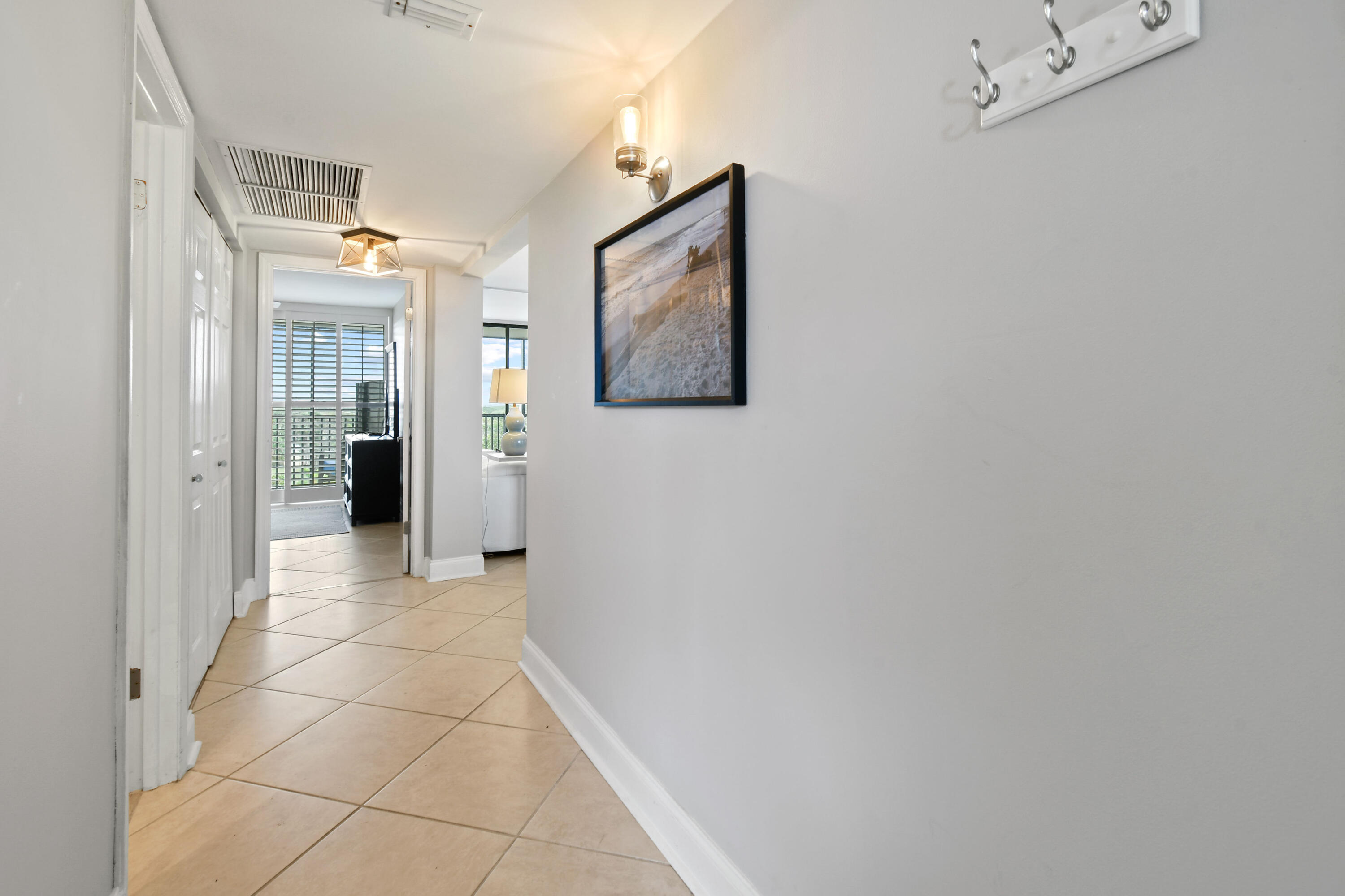 1605 Highway 1, Unit M1404 Jupiter, FL 33477 - Photo 7 of 42 a view of a hallway with paintings on the wall