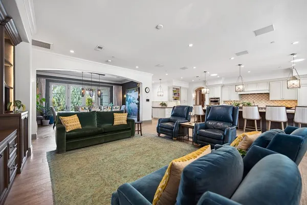 a dining room with furniture and wooden floor