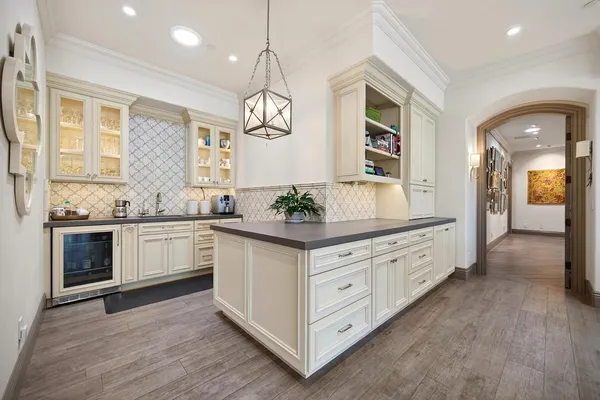 a spacious bedroom with a bed and a flat screen tv