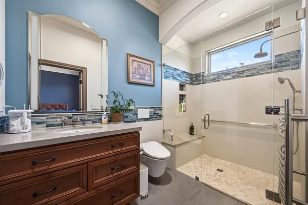 an aerial view of a house with a garden and lake view