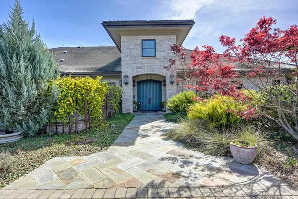 a view of a patio with table and chairs and potted plants