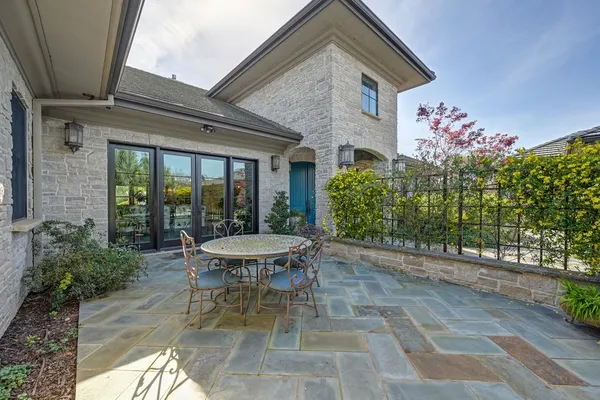 a dining room with furniture a chandelier and wooden floor