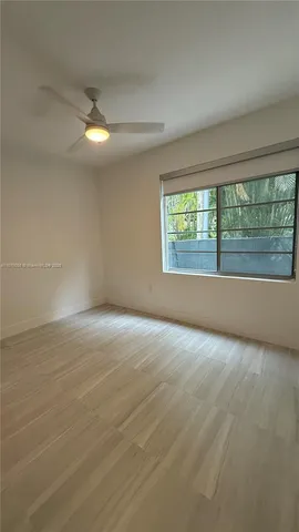 an empty room with a empty space and windows