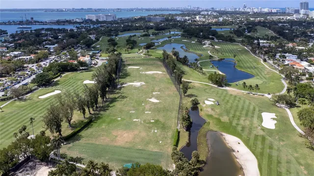 an aerial view of a house with swimming pool and garden