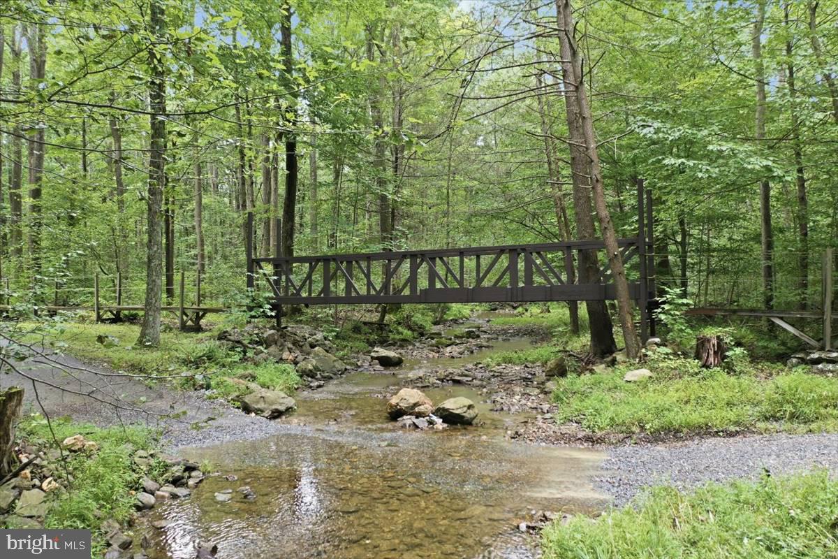 24105 Raven Rock Road Smithsburg, MD 21783 - Photo 36 of 51 Tranquil bridge over a serene stream.
