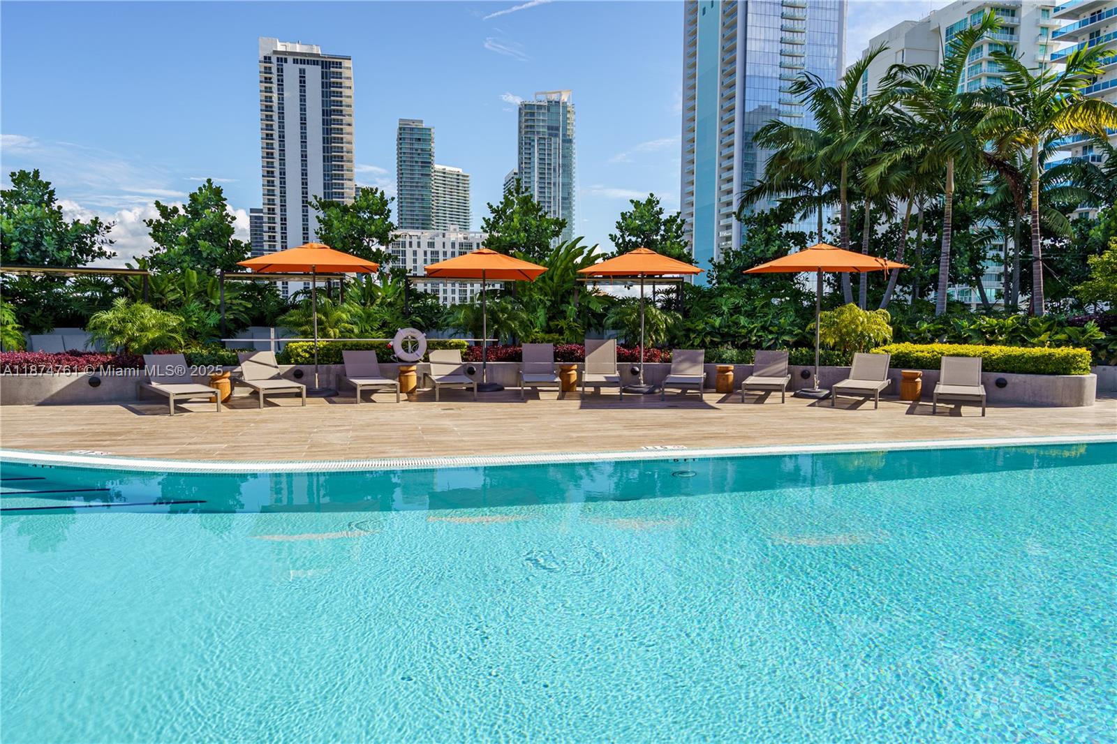 700 Northeast 24th Street, Unit 2201 Miami, FL 33137 - Photo 15 of 20 a swimming pool with outdoor seating and yard