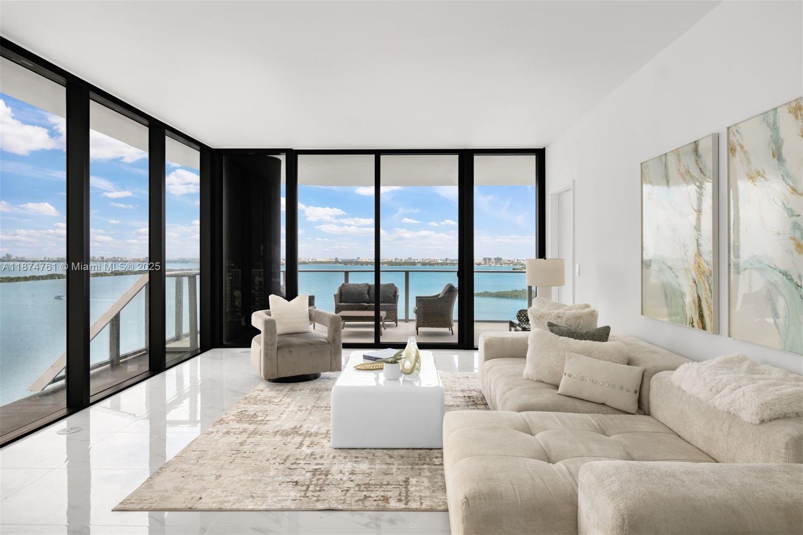 700 Northeast 24th Street, Unit 2201 Miami, FL 33137 - Photo 2 of 20 a living room with furniture and large windows