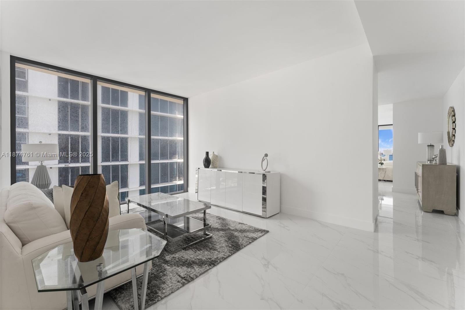 700 Northeast 24th Street, Unit 2201 Miami, FL 33137 - Photo 5 of 20 a living room with furniture and a floor to ceiling window
