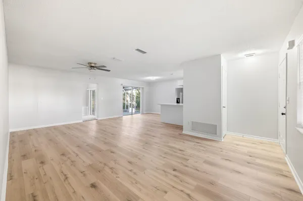a view of empty room with wooden floor