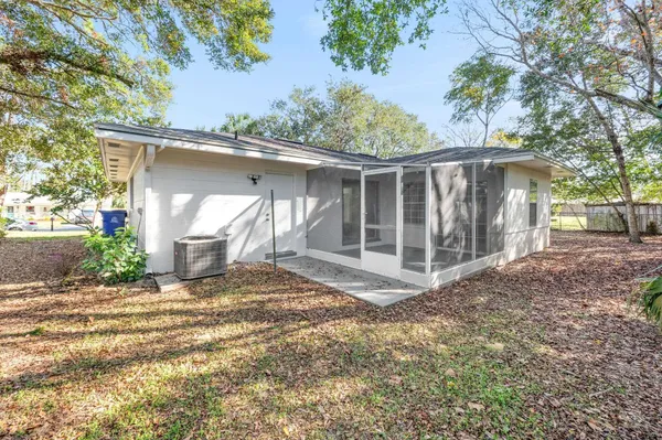 a view of a barn house next to a yard with wooden fence