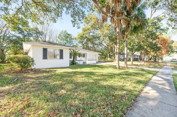 a backyard of a house with table and chairs