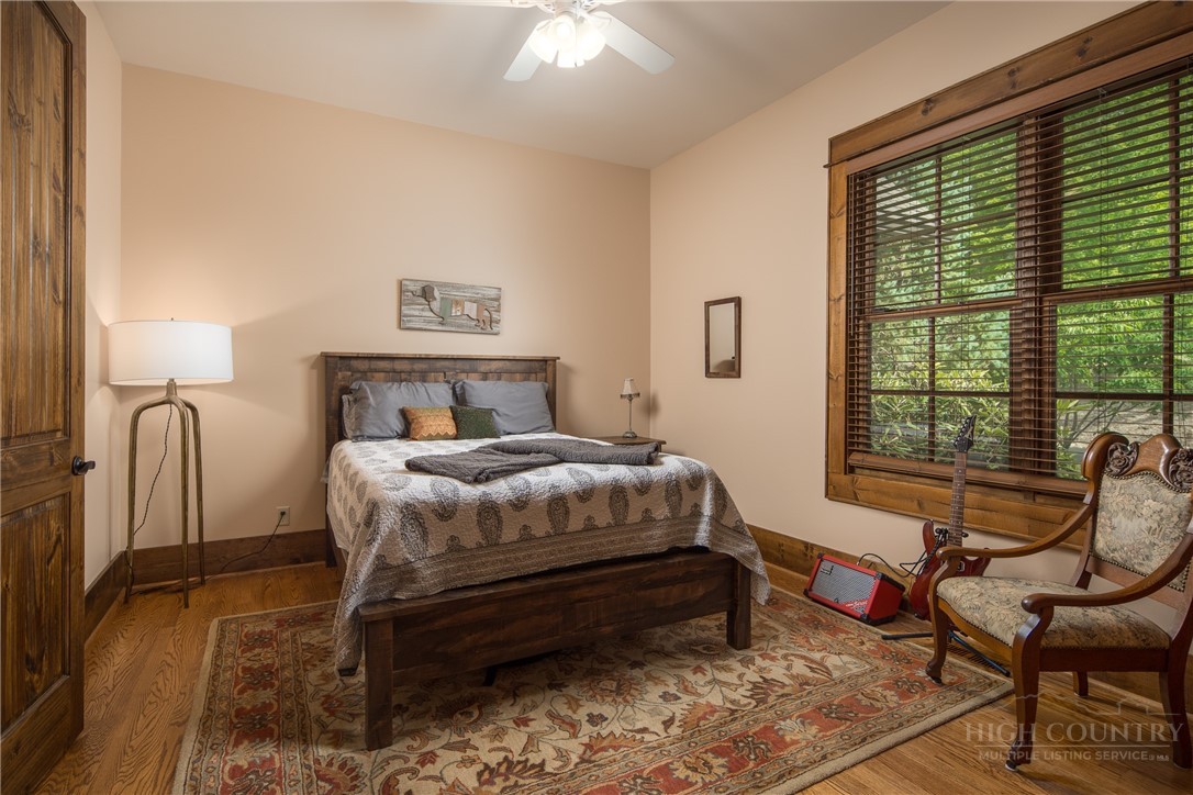 115 Passionflower Trail Boone, NC 28607 - Photo 26 of 50 a bedroom with a bed chair and window