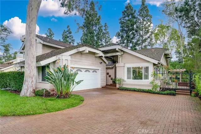 a front view of a house with a garden and plants