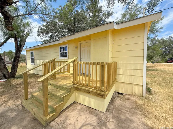 a view of a house with a backyard and stairs