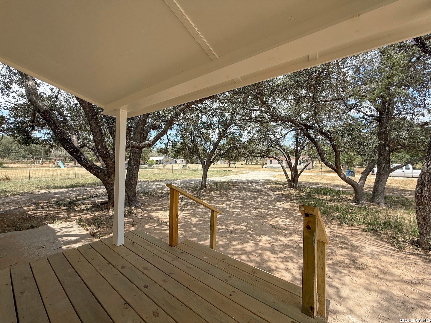 303 Davis Avenue Devine, TX 78016 - Photo 3 of 16 a view of a yard with wooden fence