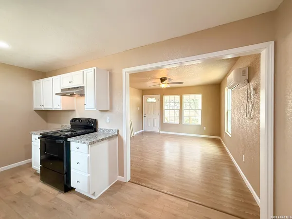 a view of a kitchen with a stove top oven