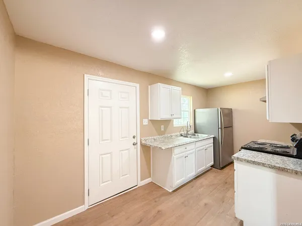 a kitchen with a stove a sink and a refrigerator