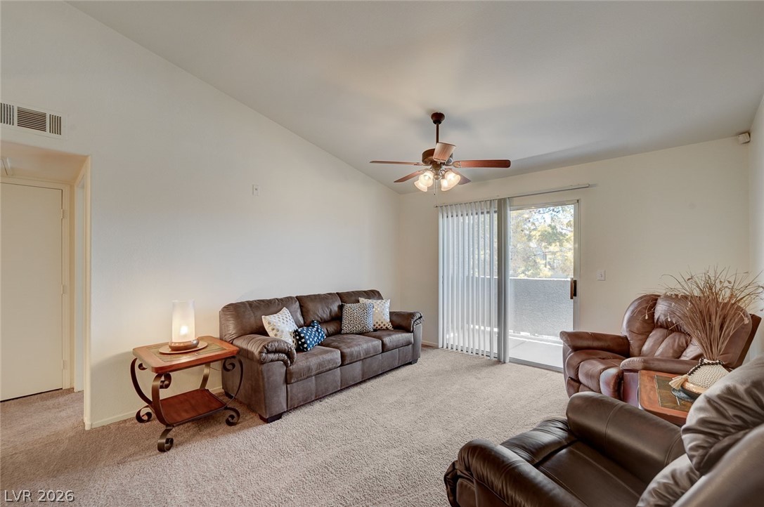 555 East Silverado Ranch Boulevard, Unit 2124 Las Vegas, NV 89183 - Photo 6 of 47 A comfortable living area with soaring vaulted ceilings and direct outdoor access.