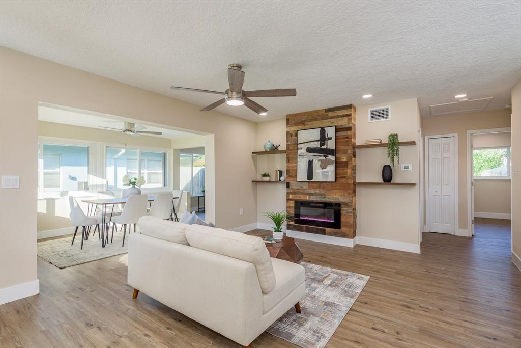 2480 Del Rio Way Dunedin, FL 34698 - Photo 11 of 35 a living room with furniture and a fireplace