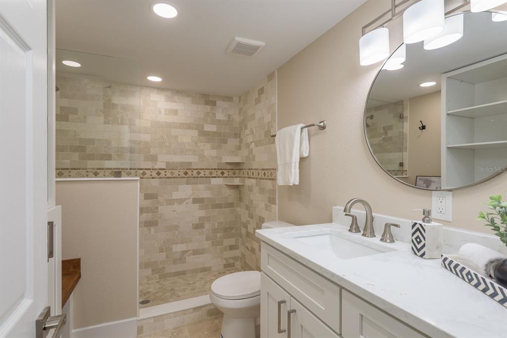 2480 Del Rio Way Dunedin, FL 34698 - Photo 18 of 35 a bathroom with a sink a toilet and a mirror