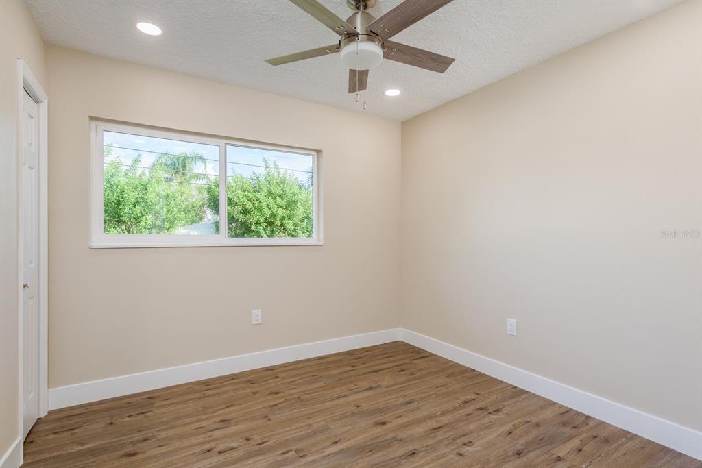 2480 Del Rio Way Dunedin, FL 34698 - Photo 19 of 35 an empty room with a window and wooden floor