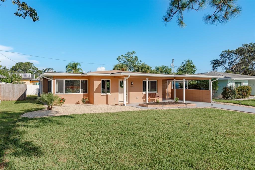 2480 Del Rio Way Dunedin, FL 34698 - Photo 2 of 35 front view of a house with a yard