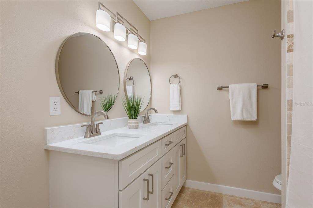 2480 Del Rio Way Dunedin, FL 34698 - Photo 21 of 35 a bathroom with a sink and a mirror
