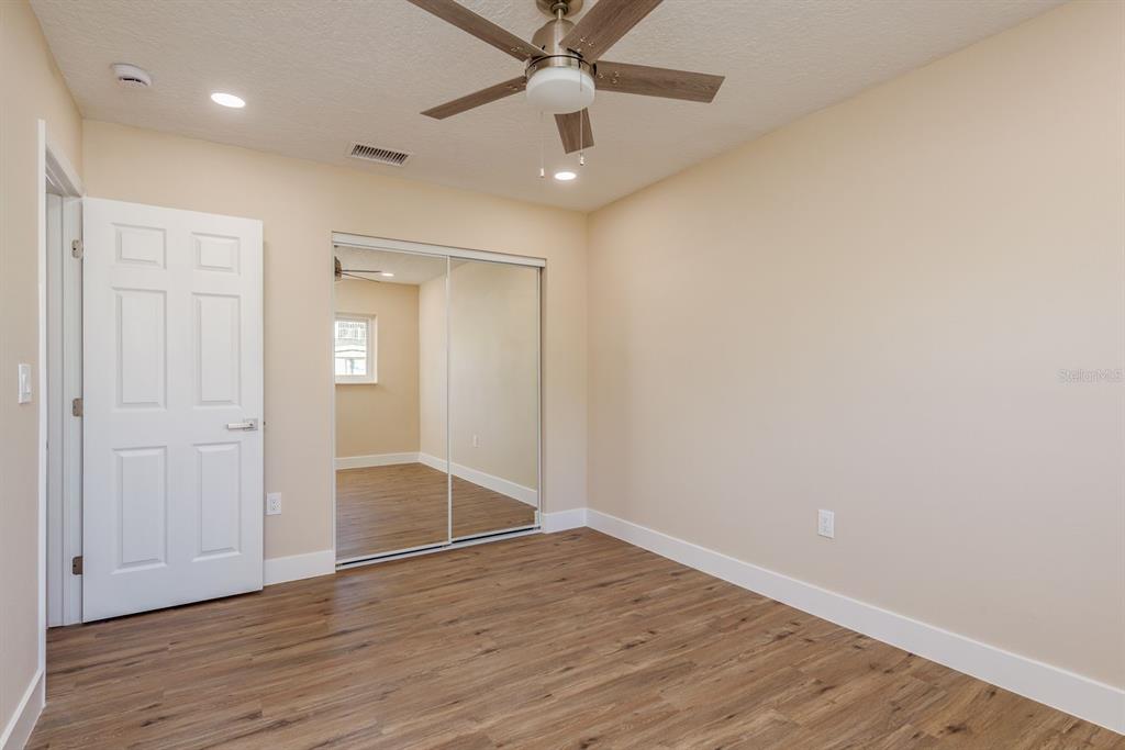2480 Del Rio Way Dunedin, FL 34698 - Photo 24 of 35 wooden floor in an empty room with a window