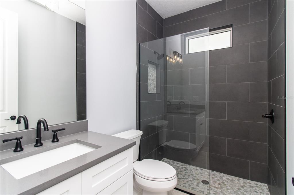 113 Douglas Street Edgewater, FL 32141 - Photo 11 of 39 a bathroom with a sink a toilet and shower