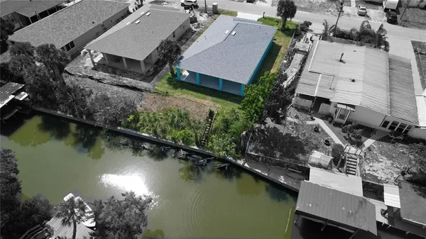an aerial view of a house with outdoor seating