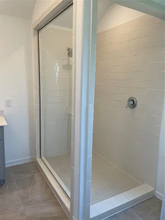 a bathroom with a glass shower door