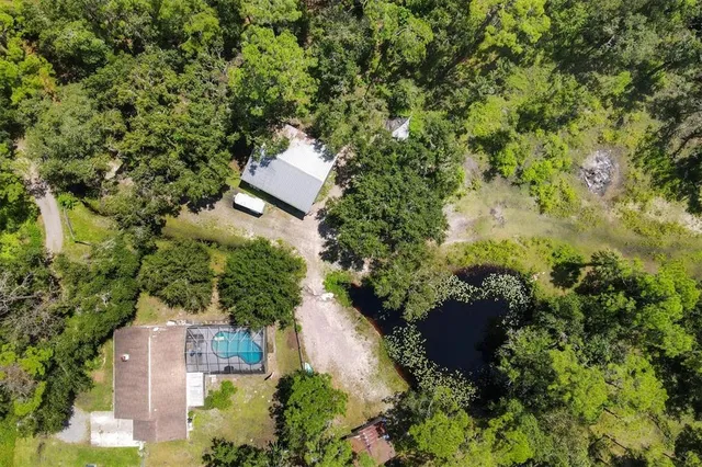 an aerial view of a house with a yard