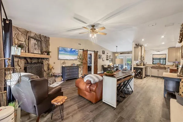 a living room with furniture a fireplace and a flat screen tv