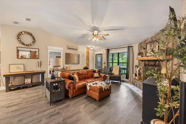 a kitchen with kitchen island granite countertop a sink stove and cabinets