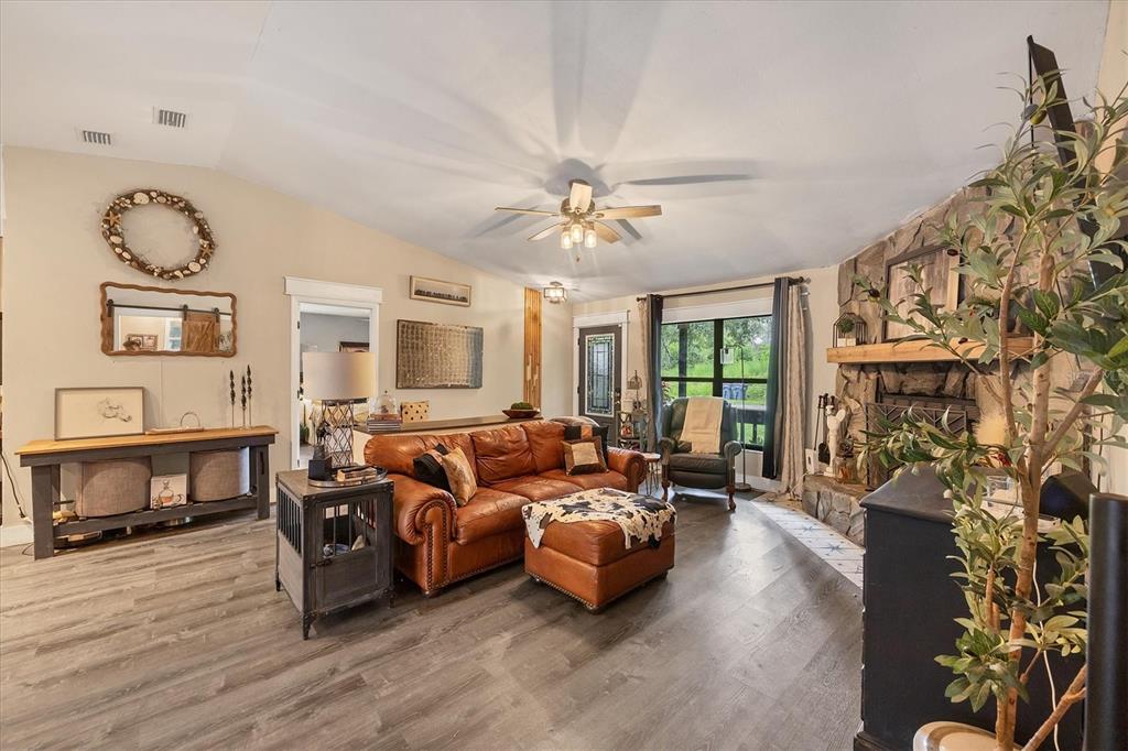 18155 Highway 62 Parrish, FL 34219 - Photo 13 of 61 a living room with furniture a fireplace and a flat screen tv