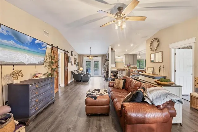 a kitchen with a sink a stove a refrigerator and chairs