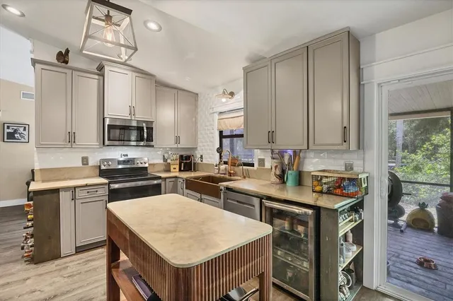a kitchen with a stove a sink a dining table and chairs