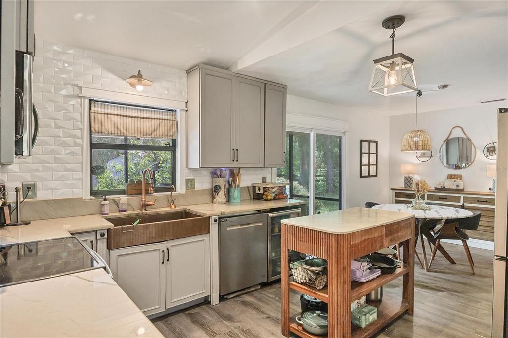 18155 Highway 62 Parrish, FL 34219 - Photo 17 of 61 a kitchen with a stove a sink a dining table and chairs